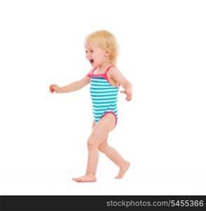 Happy baby in swimsuit running on white