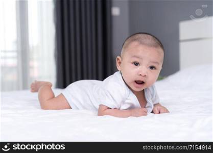 happy baby on a bed at home