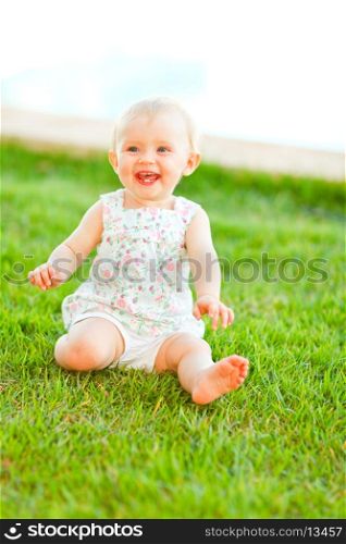 Happy baby playing on grass
