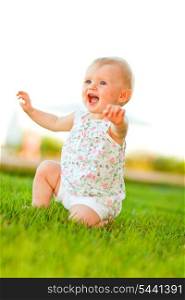 Happy baby playing on grass&#xA;