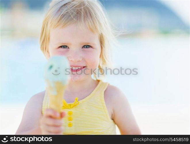 Happy baby showing ice cream