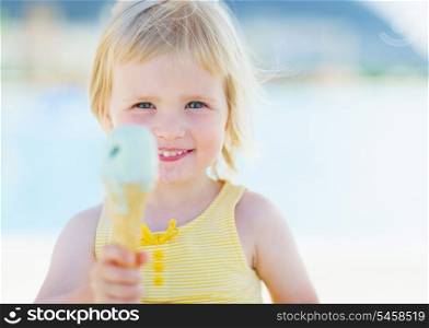 Happy baby showing ice cream