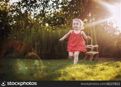 happy baby smiling. little girl running at sunset