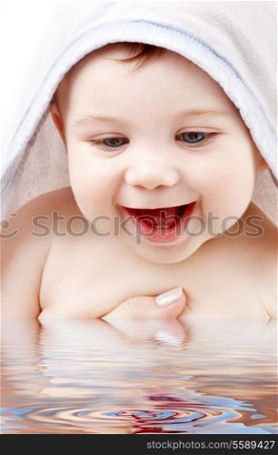 happy baby with terry hoodie robe on head in water