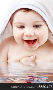 happy baby with terry hoodie robe on head in water