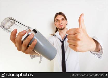 Happy bartender makes gesture. . Bartending celebration party relax alcohol liquor concept. Happy bartender makes gesture. Young male holding glass shaker showing thumb up.