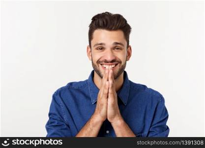 Happy Bearded man in shirt which showing pray gesture and looking up. Isolated gray background. Happy Bearded man in shirt which showing pray gesture and looking up. Isolated gray background.