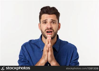 Happy Bearded man in shirt which showing pray gesture and looking up. Isolated gray background. Happy Bearded man in shirt which showing pray gesture and looking up. Isolated gray background.