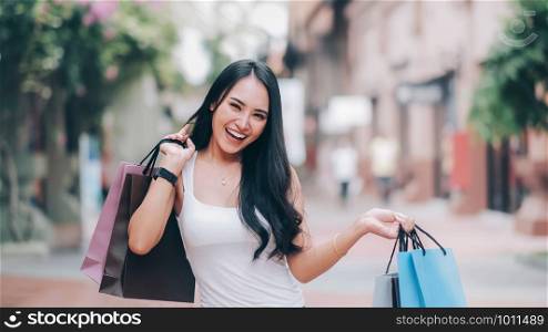 Happy beautiful asian woman with shopping bags enjoying in shopping. Lifestyle shopping and business concept.
