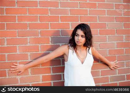 Happy beautiful brunette girl with red wall brick of background