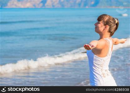 happy beautiful brunette woman looking at the sea