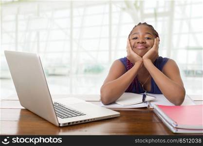 happy beautiful business african woman working with a laptop on a desk, at the office. african woman working
