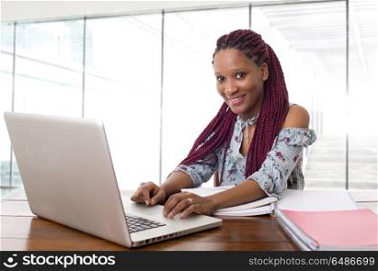 happy beautiful business woman working with a laptop on a desk, isolated on white background. working
