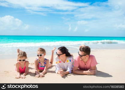 Happy beautiful family on white beach. Happy family with kids on the beach together