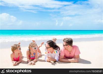 Happy beautiful family on white beach having fun. Young family on vacation having fun
