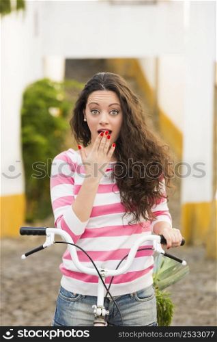 Happy beautiful girl riding her bicycle