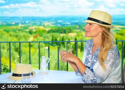Happy beautiful girl sitting in outdoors cafe, enjoying view, traveling to Europe, Italy, Tuscany, summer vacation concept