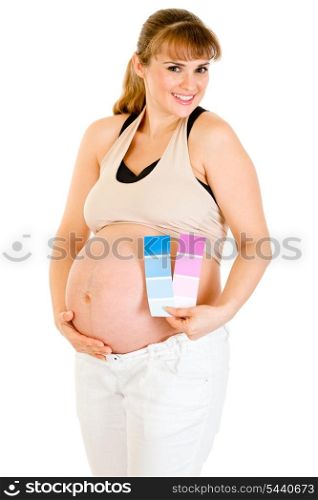 Happy beautiful pregnant woman holding color paint samples near her belly isolated on white&#xA;