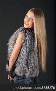 Happy beautiful woman in fur clothing looking back
