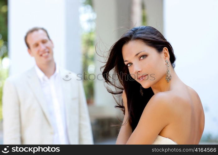 Happy beautiful woman portrait with man in blur background