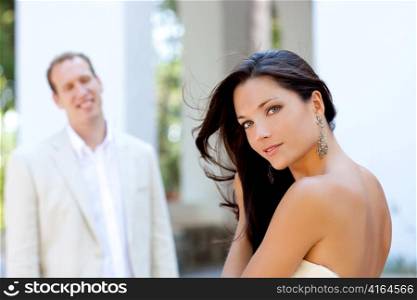 Happy beautiful woman portrait with man in blur background
