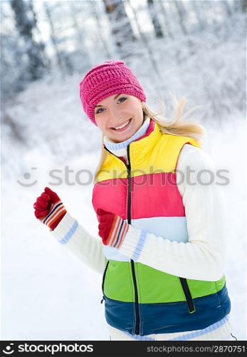 Happy beautiful woman running outdoors