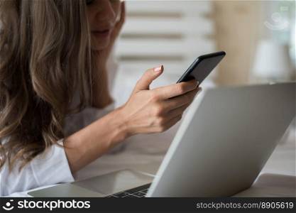 Happy Beautiful woman working on a laptop on the bed in the house