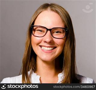 happy beautiful young caucasian woman on gray background