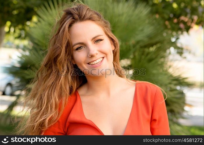 Happy beautiful young woman laughing and smiling on nature in green