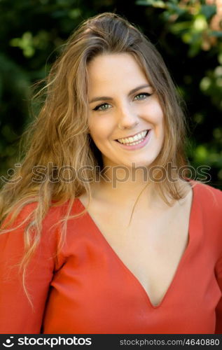 Happy beautiful young woman laughing and smiling on nature in green