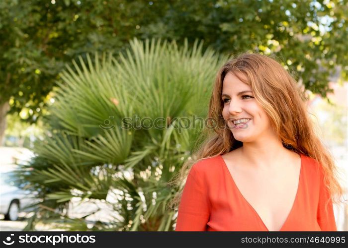 Happy beautiful young woman laughing and smiling on nature in green