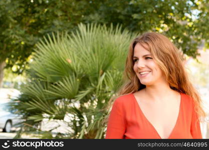 Happy beautiful young woman laughing and smiling on nature in green