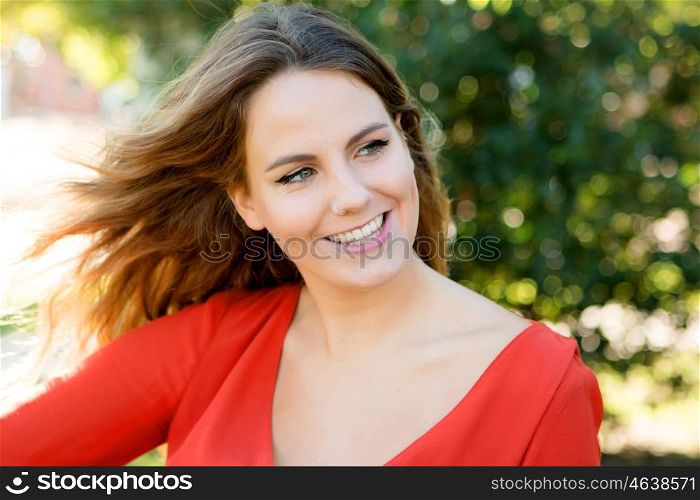 Happy beautiful young woman laughing and the wind blowing her hair
