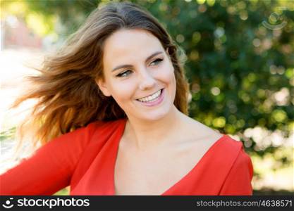 Happy beautiful young woman laughing and the wind blowing her hair