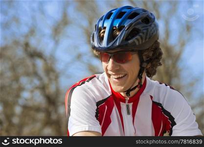 Happy bicyclist in sportswear looking away