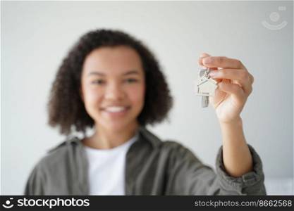Happy biracial teen girl homeowner tenant shows keys to new home, close-up. Smiling young mixed race lady holding key to apartment, focus on hand. Mortgage, housing rental service advertisement.. Happy biracial teen girl homeowner tenant shows keys to new home, close-up. Mortgage, rental housing