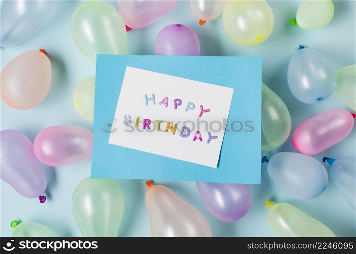 happy birthday card balloons against blue backdrop