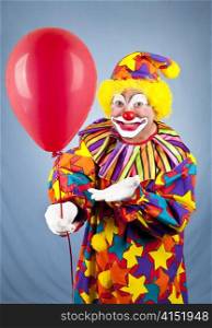 Happy birthday clown holding out a red balloon for you.