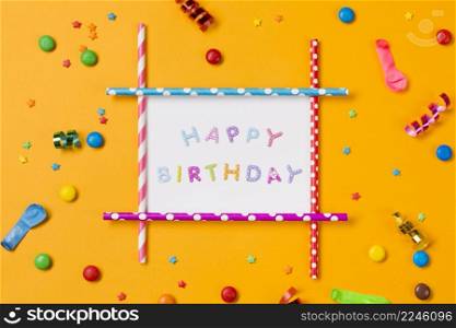 happy birthday decoration with streamer balloon gems sprinkles yellow backdrop