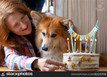 happy birthday - girl and corgi dog near cake with candles 