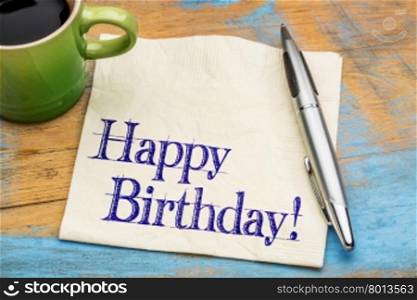 Happy Birthday greeting - handwriting on a napkin with a cup of coffee