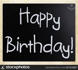 ""Happy Birthday" handwritten with white chalk on a blackboard"
