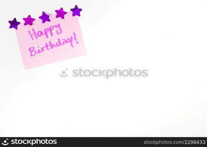 happy birthday message pink paper decorated with star shape white background
