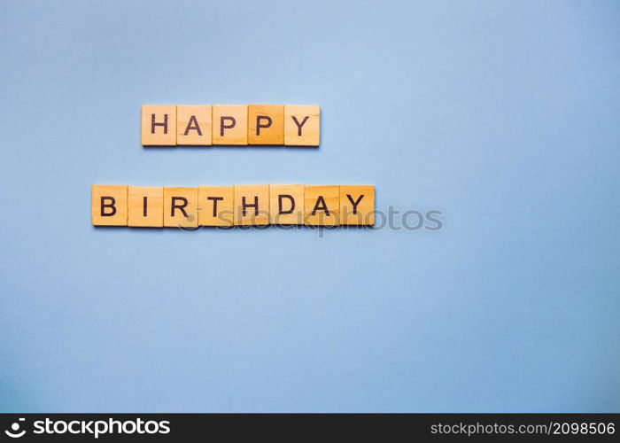 Happy birthday party, blue background with wooden text happy birthday. Ready postcard. Place for an inscription. Happy birthday party, blue background with wooden text happy birthday. Ready postcard. Place for an inscription.