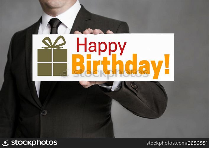Happy Birthday shield is held by businessman.. Happy Birthday shield is held by businessman