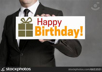 Happy Birthday shield is held by businessman.. Happy Birthday shield is held by businessman