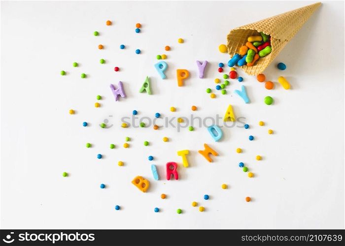 happy birthday text with candies spilling from waffle ice cream cone