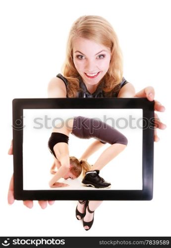 Happy blond girl showing ipad with photo of fitness fit woman doing stretching exercise. Modern young businesswoman holding tablet touchpad recommending active lifestyle. Isolated. Technology and sport.