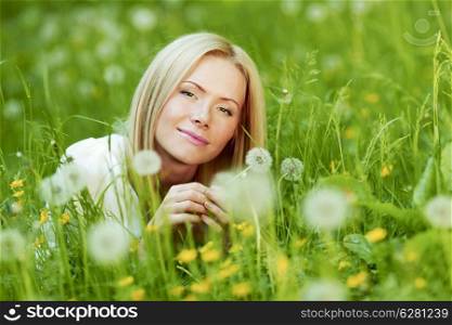 Happy blond Girl with white dandelion in spring park