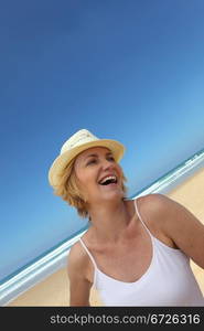 Happy blond woman oat the beach